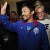 Manny Pacquiao arrives with Hall of Fame trainer Freddie Roach at the Venetian Macao in Macau, China, on Tuesday, Nov. 19, 2013, for his upcoming fight against former world champion Brandon "Bam Bam" Rios.